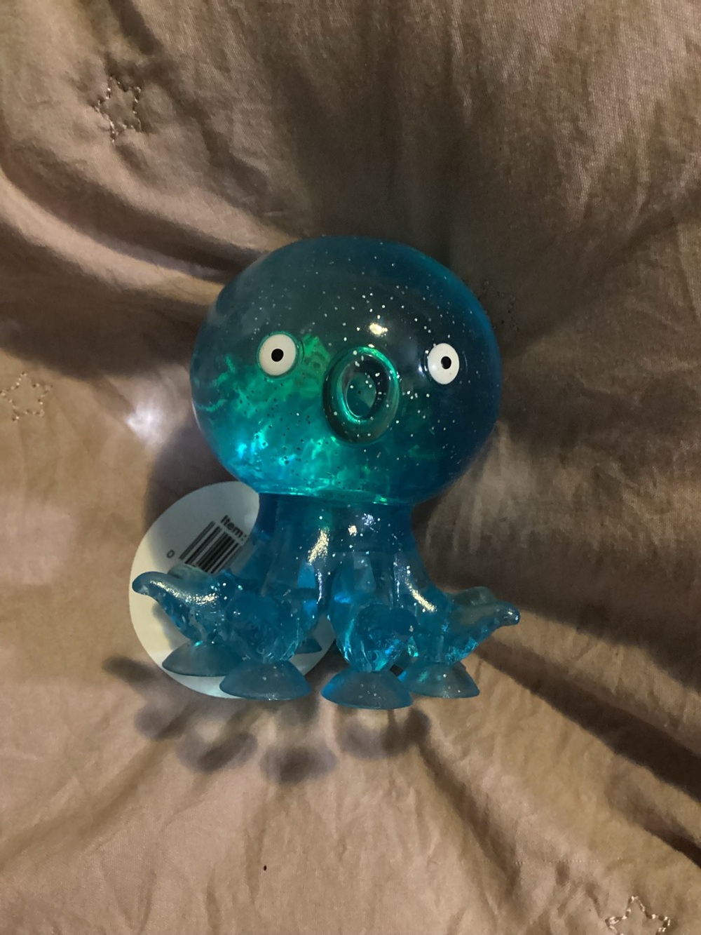 Clear Blue Octopus squishy with suction cups on the bottom to stick to your desk